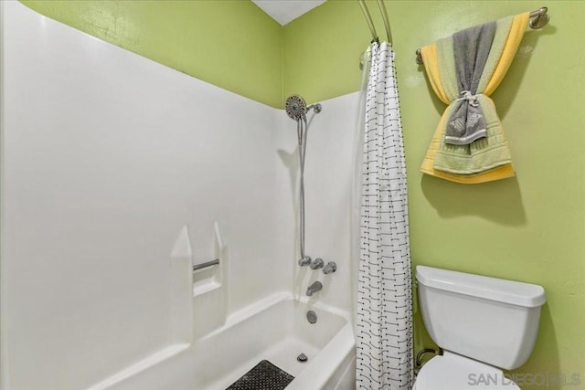 bathroom featuring shower / bath combo and toilet