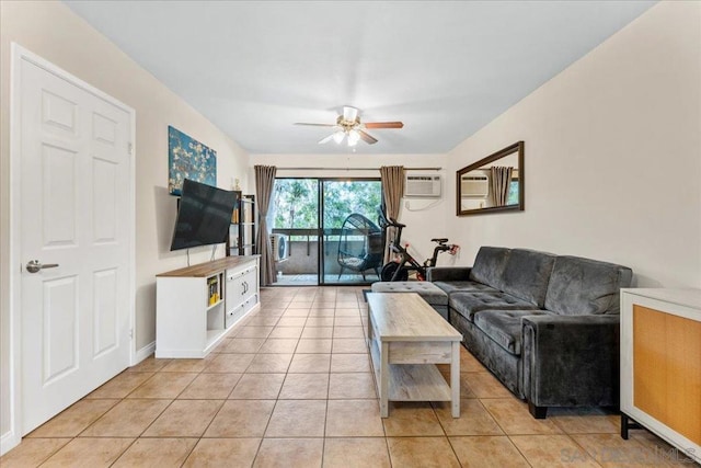 tiled living room featuring a wall unit AC and ceiling fan