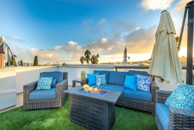 patio terrace at dusk featuring an outdoor living space with a fire pit