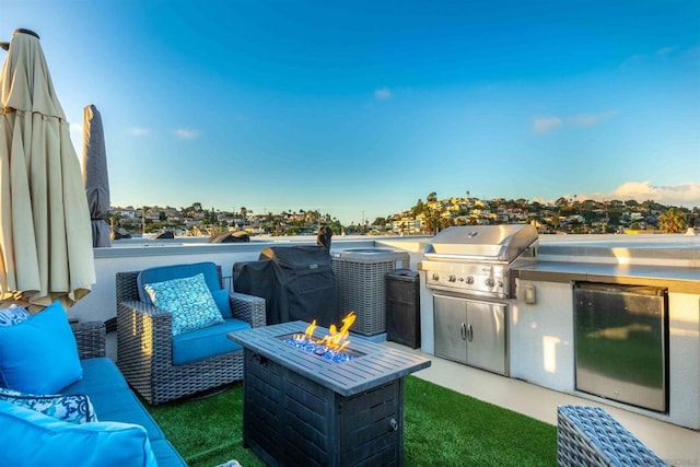 view of patio featuring area for grilling, an outdoor living space with a fire pit, and grilling area