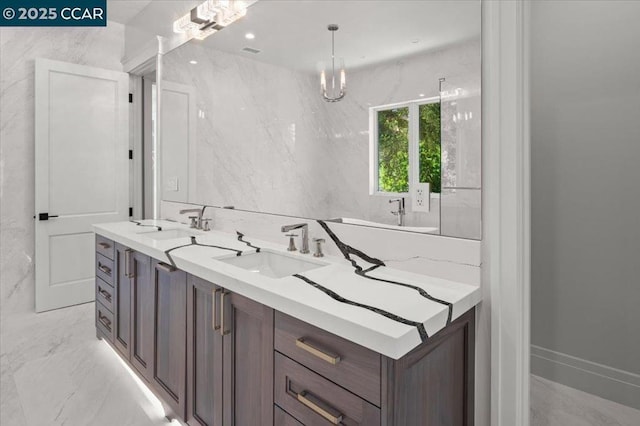 bathroom with vanity and an inviting chandelier