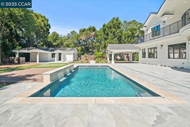 view of swimming pool with a patio and pool water feature