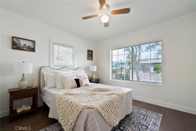 bedroom with ceiling fan and dark hardwood / wood-style floors