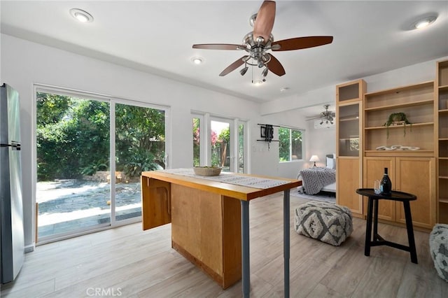 kitchen with stainless steel refrigerator and light hardwood / wood-style flooring