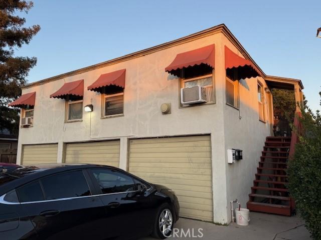 exterior space with cooling unit and a garage