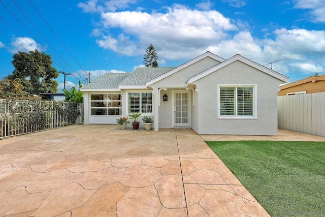 single story home with a front lawn and a patio