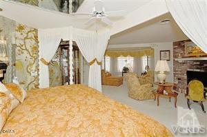 bedroom featuring a brick fireplace