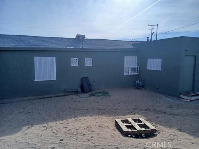 rear view of property featuring cooling unit