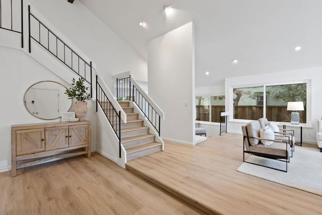 interior space with light hardwood / wood-style floors and a high ceiling