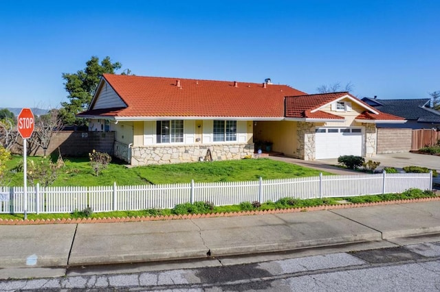 ranch-style house featuring a garage and a front lawn