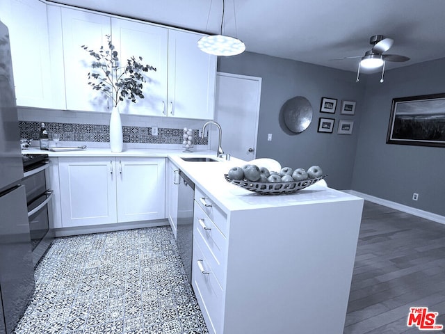 kitchen with sink, backsplash, hanging light fixtures, and white cabinets