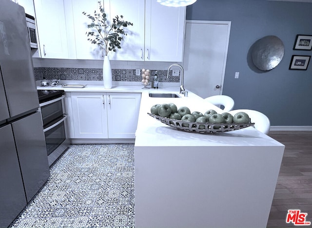 kitchen with white cabinetry, sink, and appliances with stainless steel finishes