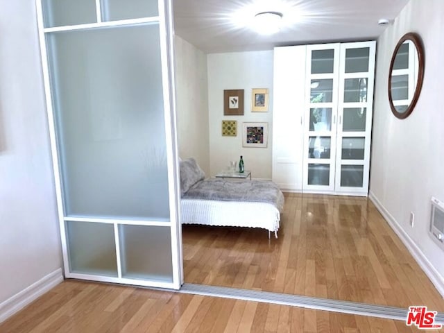 unfurnished bedroom with hardwood / wood-style floors