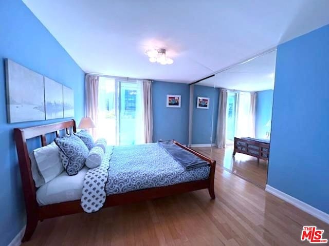 bedroom with hardwood / wood-style floors