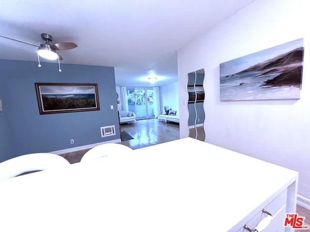 bedroom with ceiling fan and dark hardwood / wood-style flooring