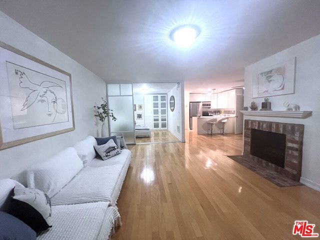 living room featuring a fireplace and light hardwood / wood-style floors