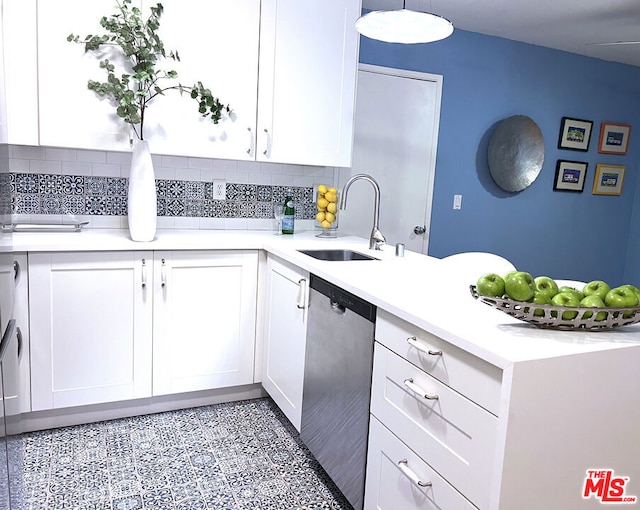 kitchen with white cabinetry, dishwasher, sink, and decorative backsplash