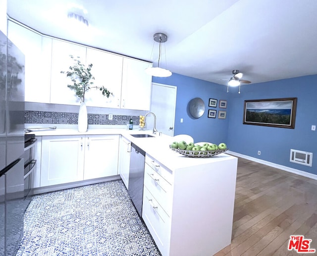 kitchen with sink, white cabinets, decorative light fixtures, stainless steel dishwasher, and kitchen peninsula