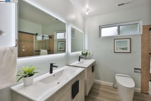 bathroom featuring hardwood / wood-style flooring, vanity, and toilet