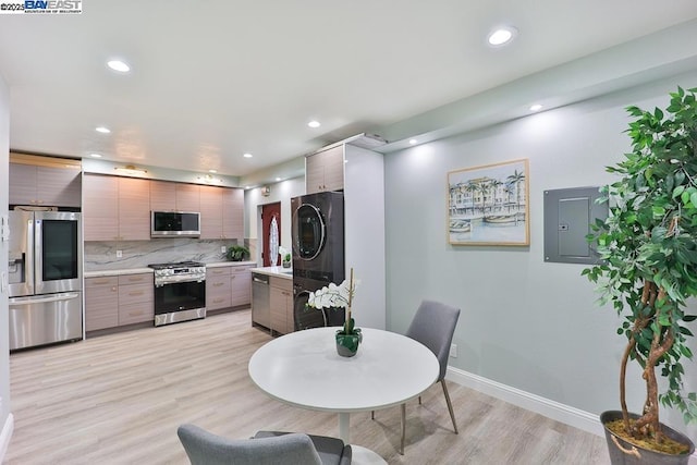 dining room featuring electric panel and light hardwood / wood-style floors