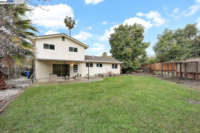 back of property featuring a patio and a lawn