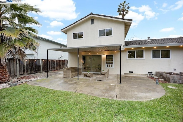 rear view of house featuring a yard, an outdoor living space, and a patio