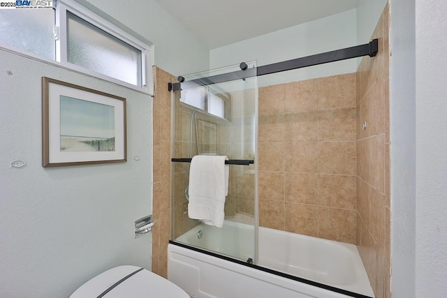 bathroom with shower / bath combination with glass door and toilet