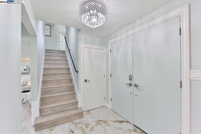 foyer entrance with a chandelier