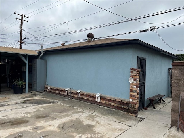 view of property exterior with a patio area