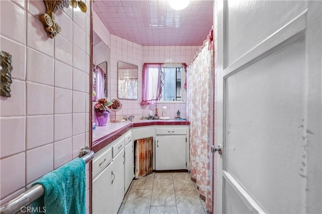 bathroom with tasteful backsplash and tile walls