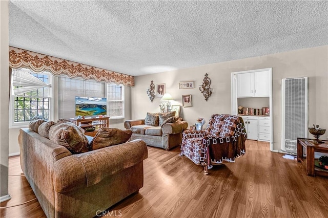 living room featuring hardwood / wood-style flooring and a textured ceiling