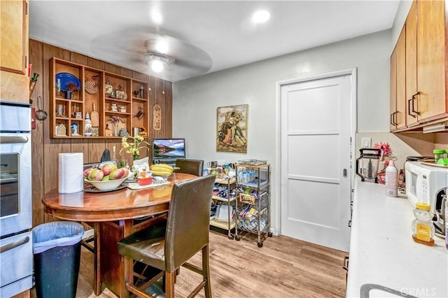 dining space with ceiling fan and light hardwood / wood-style floors