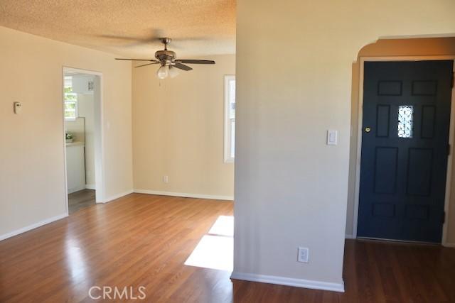 2441 W Repetto Ave, Montebello, CA 90640 - spare room with ceiling fan, wood finished floors, arched walkways, baseboards, and a textured ceiling