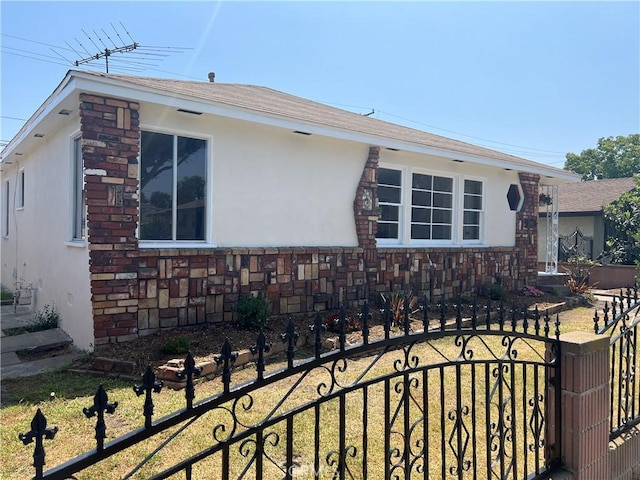 2441 W Repetto Ave, Montebello, CA 90640 - view of front of home with a fenced front yard, stucco siding, a gate, and roof with shingles