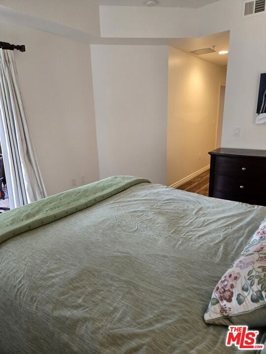 bedroom featuring dark hardwood / wood-style flooring