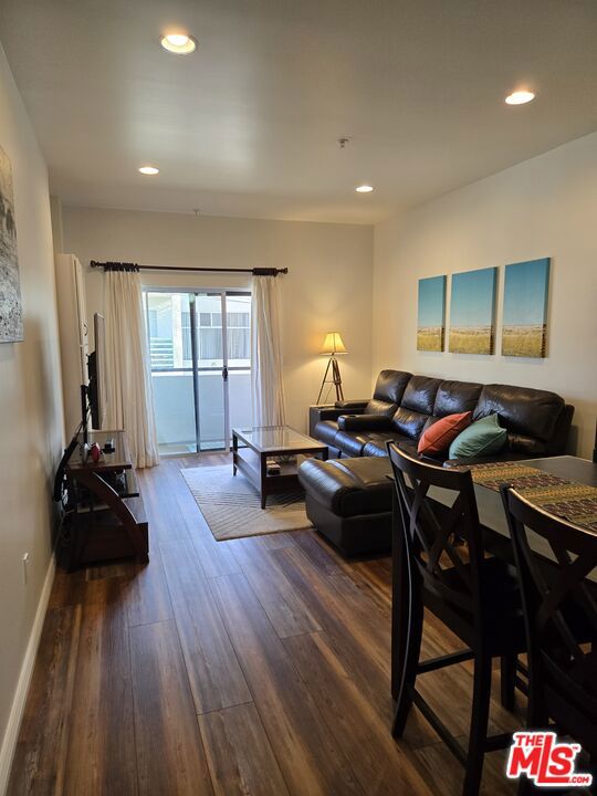 living room with dark wood-type flooring