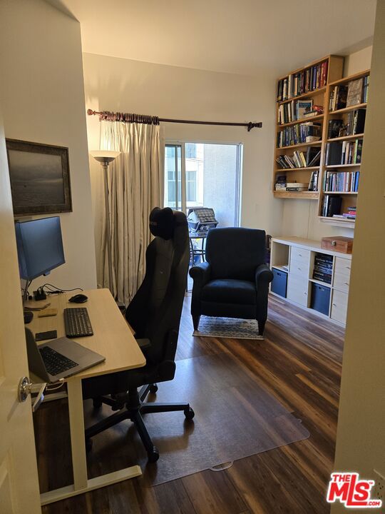 home office with dark hardwood / wood-style flooring