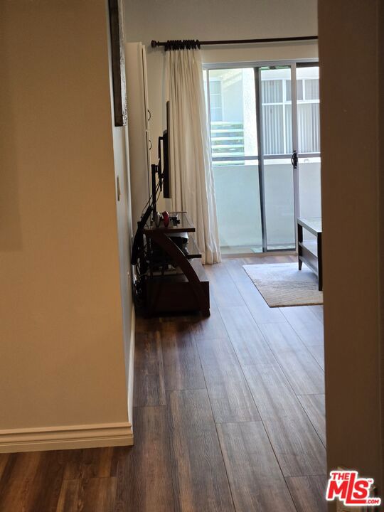 hallway with dark wood-type flooring