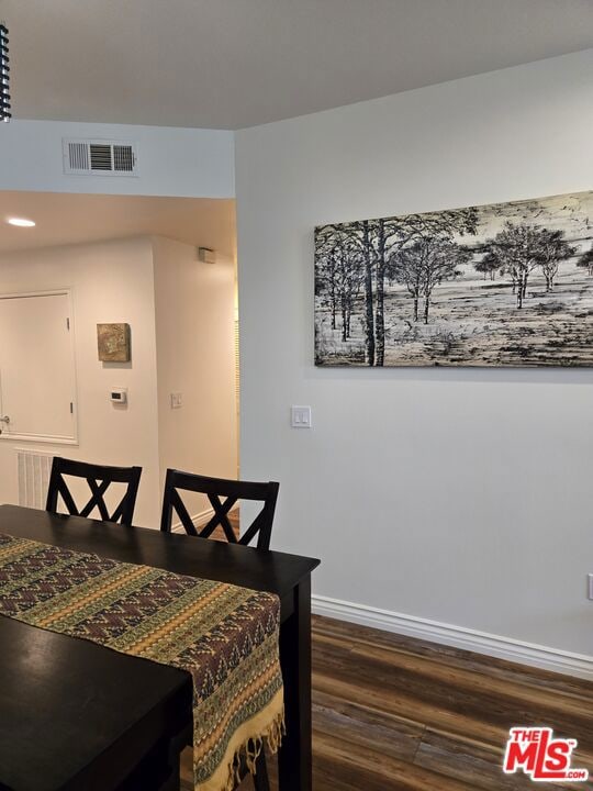 dining space with dark hardwood / wood-style floors