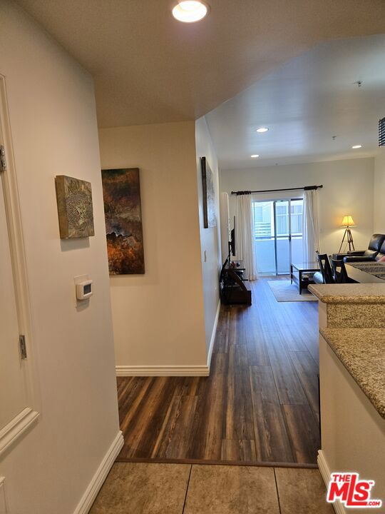 corridor featuring dark hardwood / wood-style floors