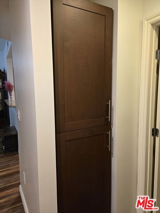 hallway with dark hardwood / wood-style flooring