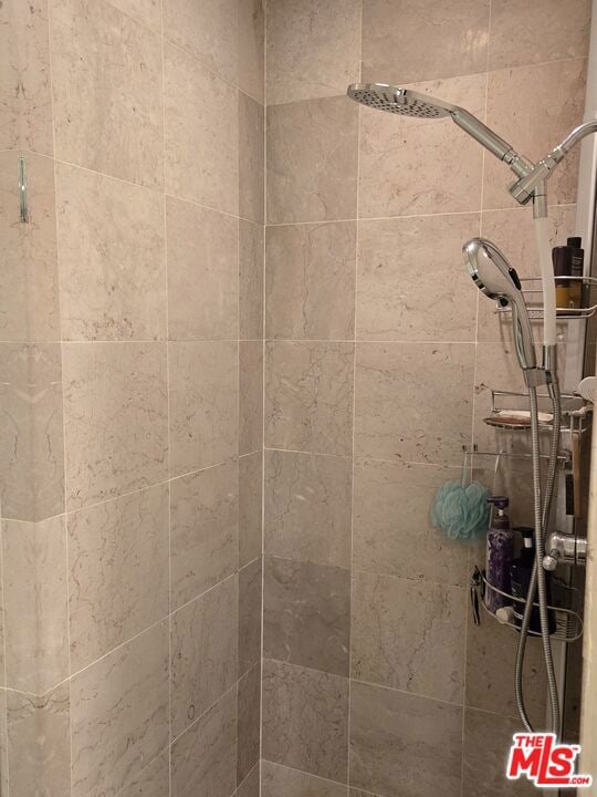 interior details featuring a tile shower