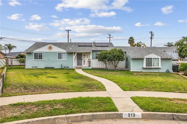 single story home featuring a front yard and solar panels