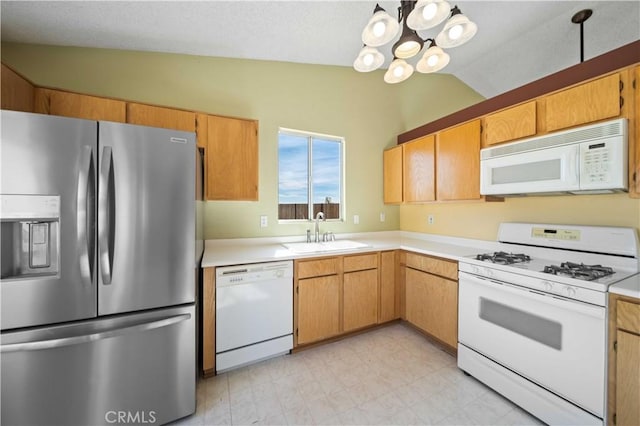 kitchen featuring an inviting chandelier, sink, white appliances, and vaulted ceiling