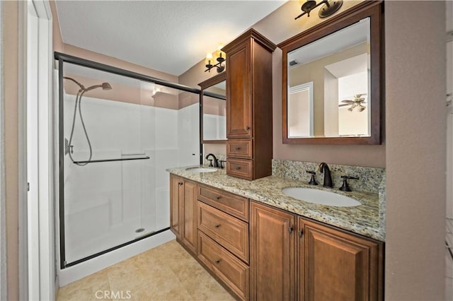 bathroom with vanity, a shower with shower door, and tile patterned flooring