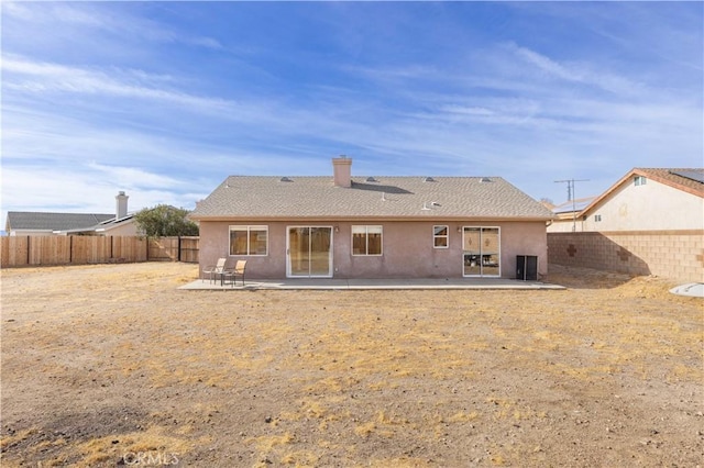 back of property with a patio