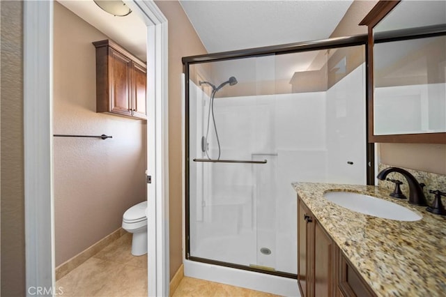 bathroom with vanity, toilet, tile patterned flooring, and a shower with door