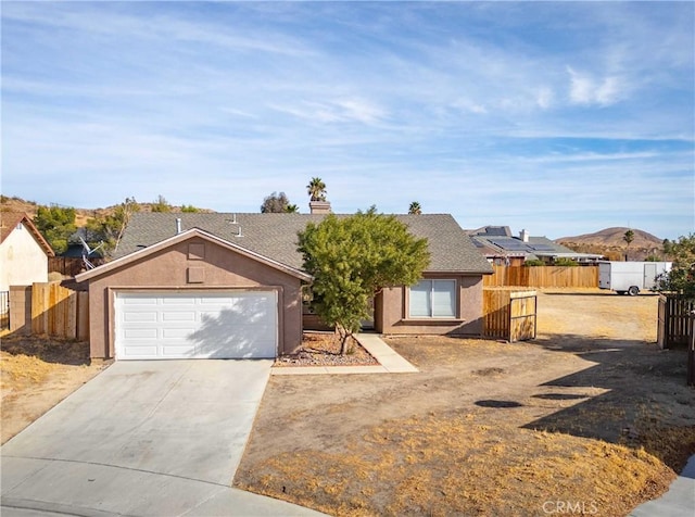 ranch-style home featuring a garage and a mountain view