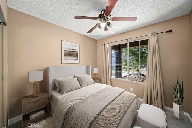 bedroom featuring ceiling fan and a textured ceiling