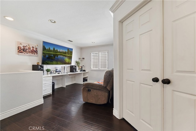 office featuring dark wood-style floors, ornamental molding, built in desk, and recessed lighting